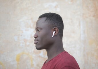 Obraz premium Young Black man listening with wireless earbuds