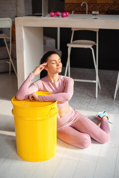 Young woman in activewear resting after training at home