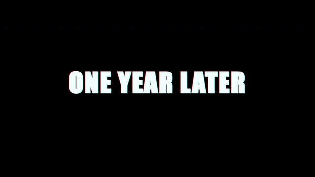 One year later text with glitch effect on black background 4k