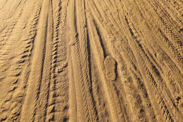 Fototapeta premium Texture of Red Soil with Vehicle Tracks