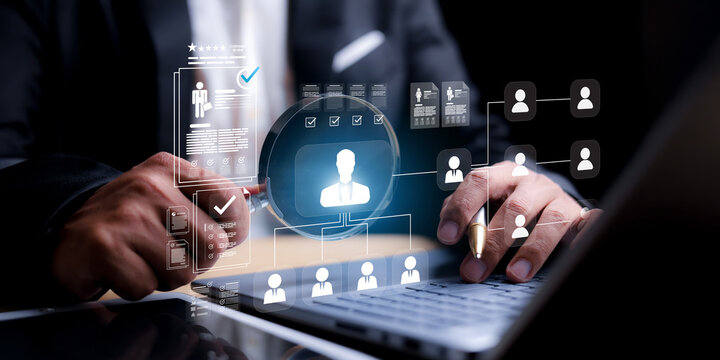 HR manager using a laptop and magnifying glass graphic to search and select candidate profiles for recruitment online.
