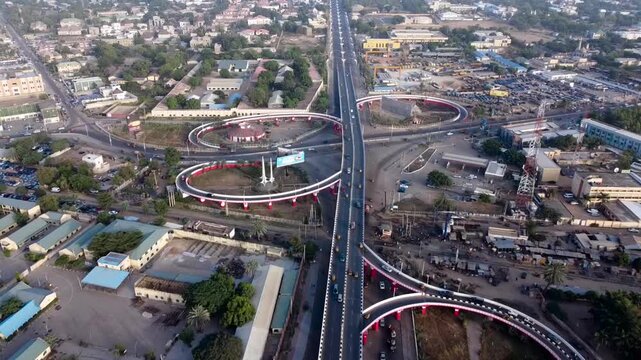 A drone shot captures the Kano City Gate and a major road interchange highlighting modern infrastructure traffic movement and urban growth in Kano.
