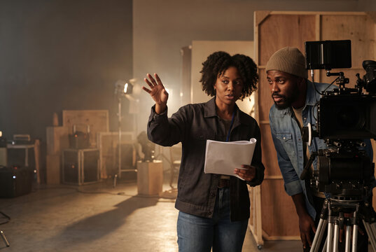 Director discussing a shot list with cinematographer on set