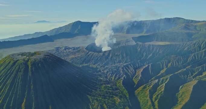 Aerial view amazing Bromo volcano constantly spews white smoke from its crater.
The Bromo volcanoes are lined up beautifully.
A sea of ​​white mist covers the bottom and surrounds the volcano.