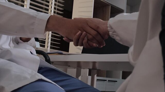 Two asian women doctors discuss meeting doctor's office medical clinic looking x-ray film consulting patient disease. Asian medical lab young women talking together discussing healthcare teamwork