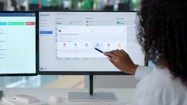 HR Manager Carefully Reviews Employee Payroll On Computer Screen