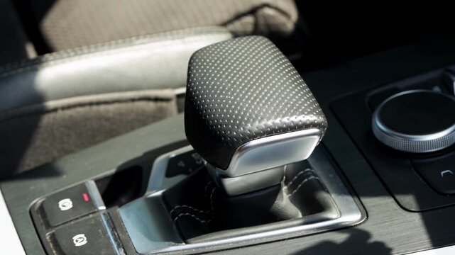 Modern car interior showing automatic gear selector, contemporary design of transmission shift lever and dashboard controls, luxury vehicle cockpit details, automotive engineering, DSG