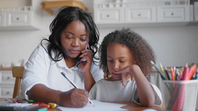 Working motherhood, african american woman work from home and parenting daughter. Portrait of multitasking careful mom communicating with colleagues by phone and her child at home, modern parenthood