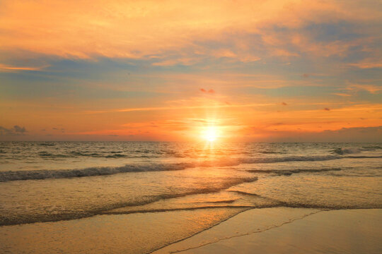 Golden hour sunset reflects on ocean waves