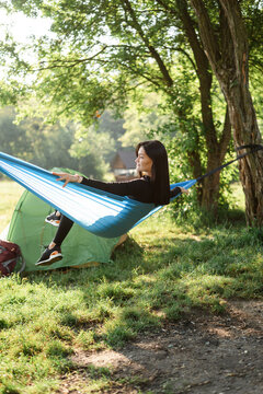 Sport girl sit on hammock and enjoy nice view