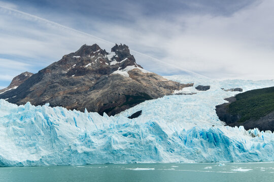 Stunning Ice Landscape Glacier, Mountains, and Water Under Cloudy Sky