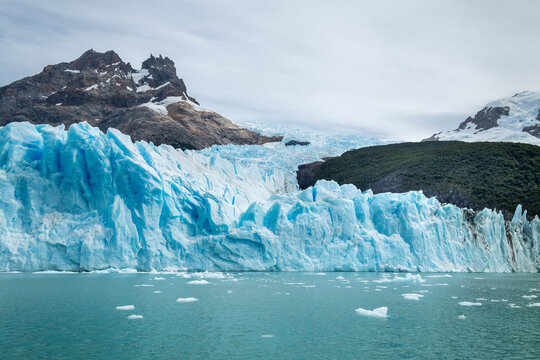 Stunning blue glacier ice in Patagonian landscape with mountain