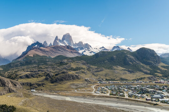Panoramic view of small town nestle below majestic mountain peaks