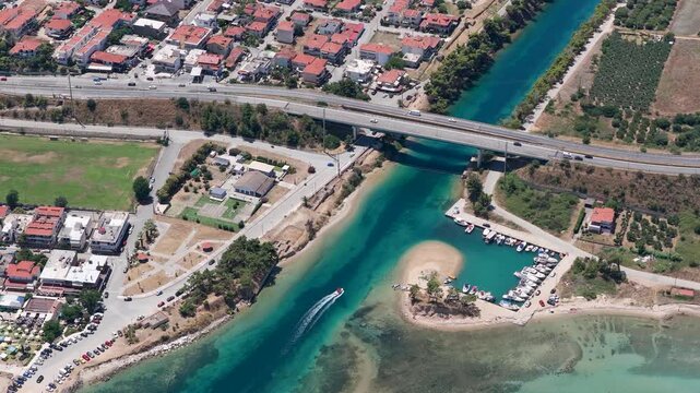 Aerial View of Small Harbor with Boats and Passing Speedboat