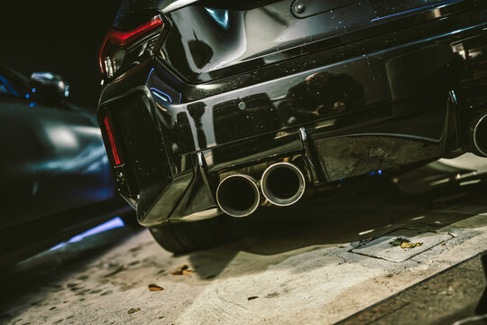 Black sports car exhaust pipes and bumper design