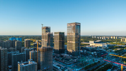 Obraz premium Urban new district with towering skyscrapers under construction and bustling site landscape