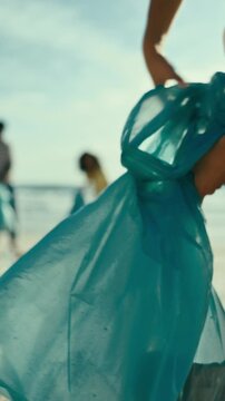 Woman, hands or cleaning beach with bag for recycling plastic, save planet or earth day. Female person, volunteer or cleaner with dirt for community service or environmental hygiene on sandy shore