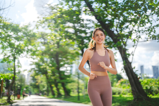 Beautiful asian exercise woman running at outdoors public park breathing fresh air wellness workout healthy lifestyle