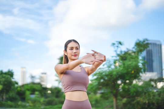 Beautiful asian female stretching arm for running exercise workout fitness woman wear sports outfit