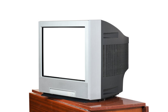 An old television with an isolated screen sits on a vintage bedside table from the 1990s or 1980s against a white background.