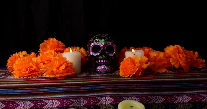 Dramatic horizontal footage presenting dark skull decorated with metallic paint and magnolia flowers for spooky holiday banners and dark arts media.