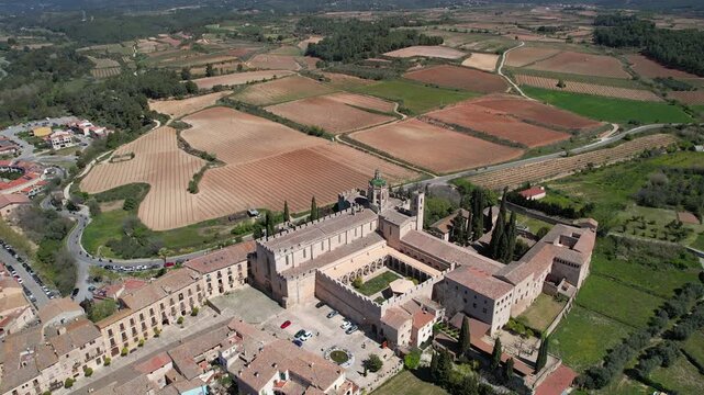 Drone footage of Santa Maria de Poblet Monastery on sunny spring day. Tarragona Province, Spain.