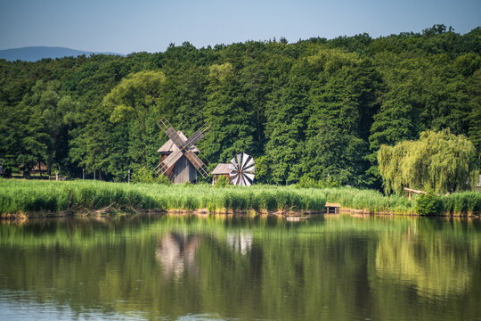 Traditional Wooden Windmill by Lake in Romania