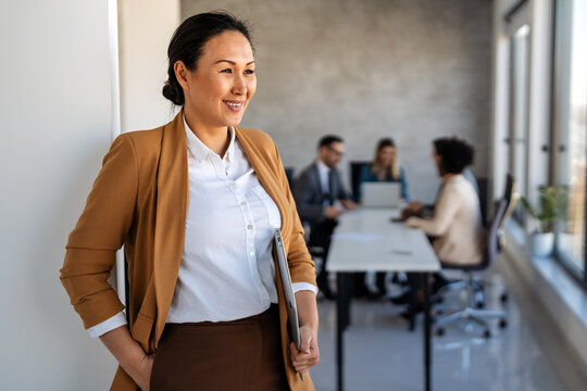 Successful executive standing proudly in office, representing business growth, partnership
