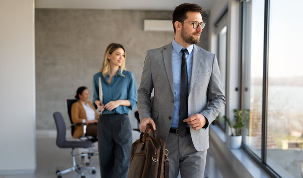 Professional in office environment, highlighting teamwork, collaboration, leadership, and innovation