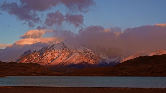 Timelapse of sunrise shot with dramatic alpenglow above Torres del Paine peaks
