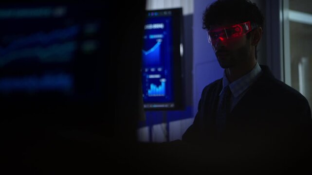 Business executive wearing smart glasses analyzing digital dashboards and business intelligence metrics in a modern office, demonstrating AI powered analytics and data driven decision making