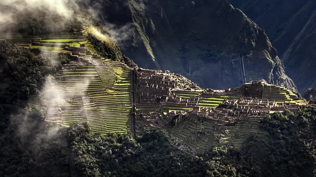 World famous Machu Picchu Inca citadel viewed through mist in Andes. Aerial