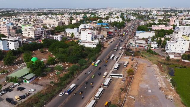 National highway 65 with traffic flow, Dargah, Graveyard and buildings at Patancheruvu, hyderabad, telangana, india. day time, push in shot, drone shot, 4k.
