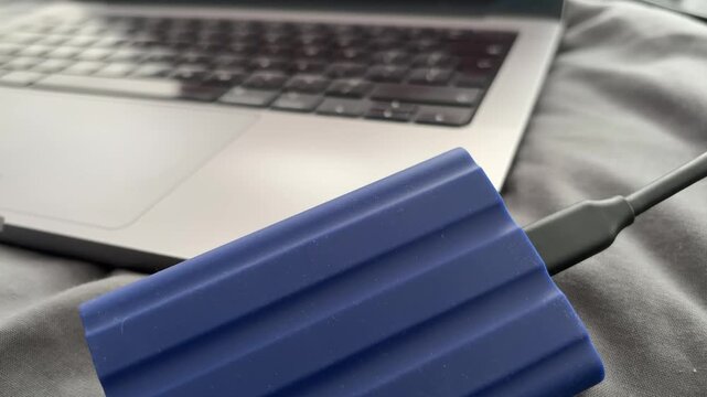 Portable External SSD Connected to Laptop With USB Cable