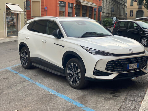 White MG HS SUV parked on a street in a European city