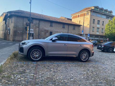 Silver Audi Q5 Sportback parked on a cobblestone street in a European town