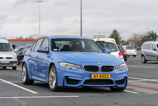 Nancy, France - March 3rd 2019 : View on a blue BMW M3 F80 finished in Yas Marina Blue parked on a parking lot with other cars behind.