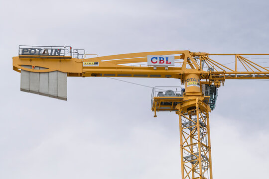 Luxembourg City, Luxembourg - July 13th 2026 : View on a flat-top tower crane Potain MDT 319 on a construction site for the construction of a building.