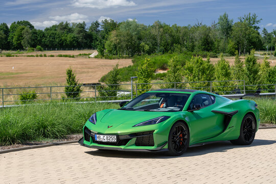 Arlon, Belgium - June 22nd 2026 : View on a green Chevrolet Corvette C8 Z06 parked on a parking lot with vegetation in the background.
