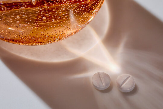 Water glass and two white pills