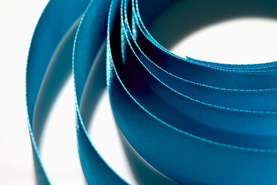 Close-up of blue ribbon on white background