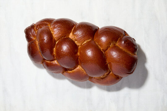 Overhead view of Challah bread on white background