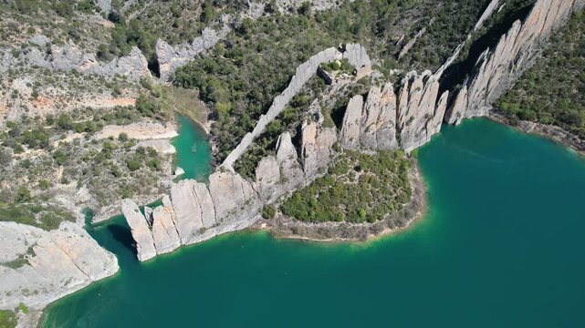Drone footage of Muralla de Finestres and Canelles Reservoir on sunny spring day. Huesca, Aragon, Spain.
