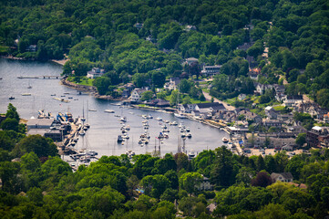 Elevated summer view of Camden Harbor, boats, marina, wooded town, and Penobscot Bay from Mount Battie in coastal Maine, USA. © Nick Fox