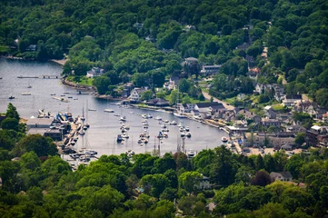 Elevated summer view of Camden Harbor, boats, marina, wooded town, and Penobscot Bay from Mount Battie in coastal Maine, USA. © Nick Fox