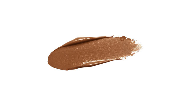 Thick swipe of caramel brown liquid foundation or nude lipstick swatch isolated on white background