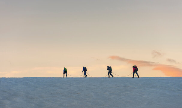 Switzerland, Mountaineers starting early morning from the Bertol Hut