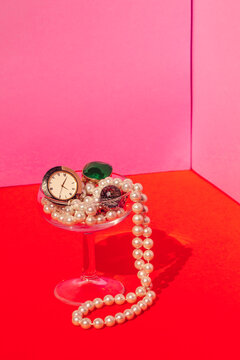 Studio shot of martini glass filled with expensive jewelry