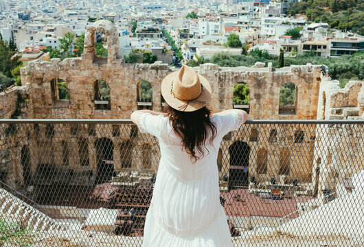 Greece, Athens, woman looking at The Odeon of Herodes Atticus at the slope of the Acropolis