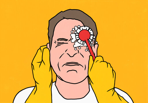 Gloved hands with scrub brush washing eye of grimacing man